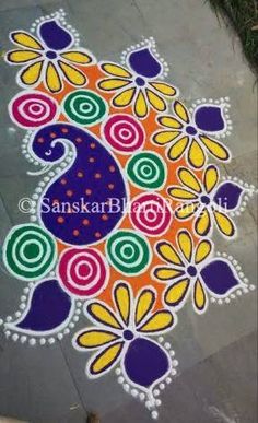 a colorful rangdi design on the ground with flowers and paisleys painted on it