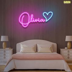 a bed in a room with a neon sign on the wall above it that says, ollivia