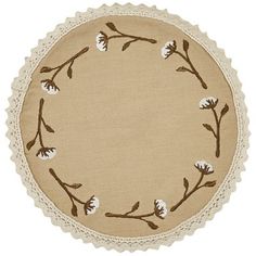 a round doily with flowers and leaves on the edges is shown in beige linen