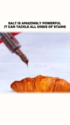 a croissant with a screwdriver sticking out of it