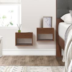 a bedroom with white walls and wood furniture