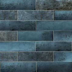 a dark blue brick wall that is very textured