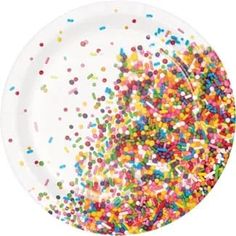 a white plate topped with sprinkles on top of a table