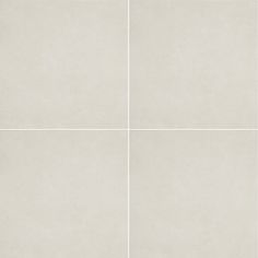 four squares of white porcelain tile with no pattern on the edges, all in different sizes and colors