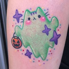 a green cat with stars and a jack - o'- lantern on its leg