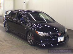 a black car parked in a parking garage