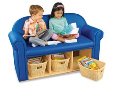 two children sitting on a blue chair with books