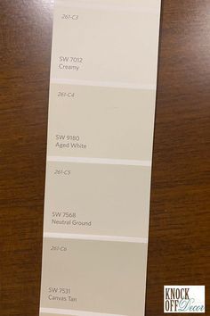 some white paint samples on a wooden table