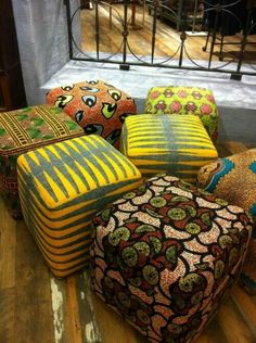 many different colored pillows sitting on the floor