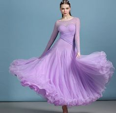 a woman in a purple dress is posing for the camera with her hands on her hips