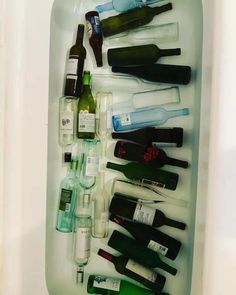 an open refrigerator filled with lots of bottles and wine glasses on top of each other