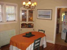 a dining room table with an orange table cloth