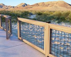 a wooden and wire fence next to a river