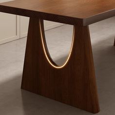 a wooden table that has some lights on it's legs in the shape of an o - ring