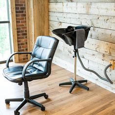 an office chair sitting next to a desk with a computer monitor on top of it