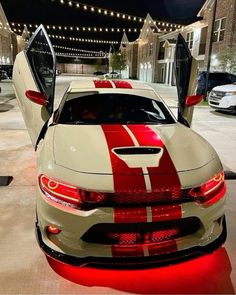 a white and red sports car parked in front of a building