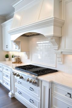 White kitchen interior with large stovetop, marble countertops, and white subway tile backsplash. Kitchen Backsplash Ideas Alabaster Cabinets, Kichen Backsplash With Creamy White Cabinets, Classic Kitchen Backsplash, Antique White Subway Tile Backsplash, Timeless Kitchen Backsplash, Kitchen Backsplash Antique White Cabinet, White Subway Tile Kitchen Backsplash, Whote Tile Backsplah In Brick Pattern, White Arabesque Tile