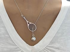 This is a beautiful lariat style tennis necklace. A tennis ball, hangs from a tennis racket thru sterling silver Necklace Chain. You will be getting a lot of compliments with this necklace . Necklace comes with 18 inch sterling silver chain with lobster claps for closer also both charm will be silver plated. u can able to adjust chain length shorter or longer if u want also u can choose birthstone if u want on them also and u can leave note about personalized initial on them as well. All persona Silver Jewellery Outfit, Classic Tennis Necklace As Gift, Elegant Tennis Necklace With Adjustable Chain As Gift, Sterling Silver Tennis Necklace Gift, Silver Tennis Necklace Gift, Classic Sterling Silver Tennis Necklace Gift, Sporty Necklace, Adjustable Tennis Necklace For Gift, Racket Tennis