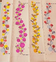 four different colored papers with flowers and leaves painted on them are lined up in rows