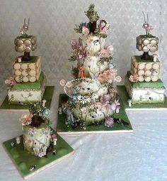 there are three cakes decorated with flowers on top of each other in the shape of animals