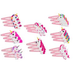 a bunch of little unicorn hair clips on a white background