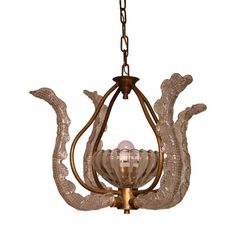 a chandelier hanging from a chain with an intricate design on the front and side