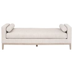 a white couch with two pillows on the back and one arm upholstered to it