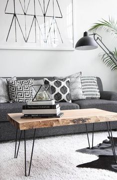 a black and white living room with some books on the coffee table in front of it