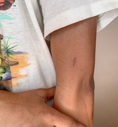 a person with a small tattoo on their left arm and the other half of his arm