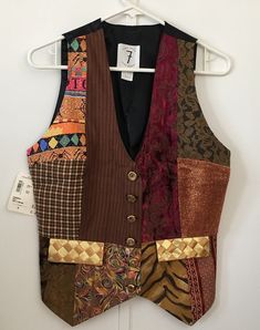 Todd Oldham Times Seven 7 Vintage Vest Early 90s Size Medium This 1990s vest was designed by Todd Oldham for his line "Times Seven." The front of the vest is made up of a patchwork of multiple luxury fabrics and intricate metal buttons. The back of the vest is black with a tie to cinch the waist. Never worn, has original tag from Nordstrom still attached. Touring Outfits, Vest Suit Men, Vintage Vest Outfit, Vest With Patches, 70s Vest, Diy Vest, Patch Vest, Cool Tights, 90s Vest