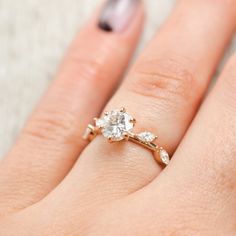 a woman's hand with a ring on it and a diamond in the middle