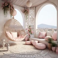 a white porch with pink cushions and pillows on the floor, in front of large arched windows