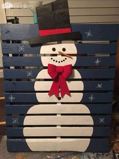 a wooden pallet with a snowman on it