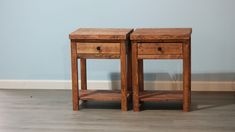 two wooden end tables sitting on top of a hard wood floor next to a wall