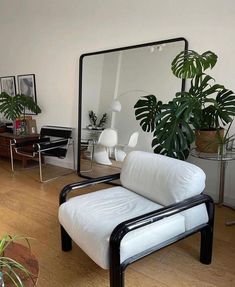 a living room filled with furniture and a large mirror over the top of it's head