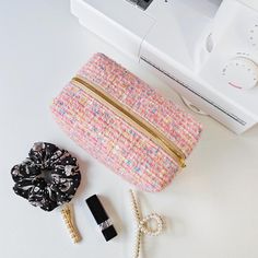 a small purse sitting on top of a table next to a hair dryer and other items