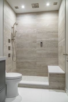 a bathroom with a walk in shower next to a toilet