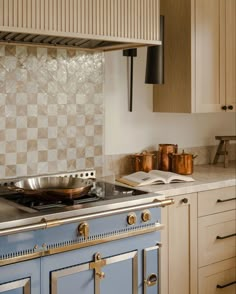 a stove top oven sitting inside of a kitchen next to wooden cabinets and counter tops