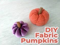 two fabric pumpkins sitting next to each other on a white surface with the words diy fabric pumpkins