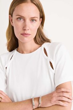 The SOLACE is Merlette's take on the classic jersey tee, foregrounding sustainability and signature details. Crafted in midweight 100% organic cotton jersey, it has a soft handfeel. Serpentine-shaped cut out details at the sleeves are ruched by hand. Cotton Jersey Top, Jersey Tops For Women, Brand Boards, Neck Lines, Tied T Shirt, Sewing Clothing, Jersey Tops, Cutout Top, Neckline Designs