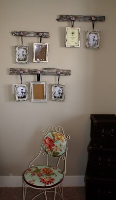 a chair sitting next to a wall with pictures hanging on it's back end