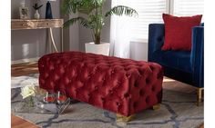 a living room with two blue chairs and a red bench in the middle of it