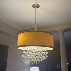 a chandelier hanging from the ceiling in a living room