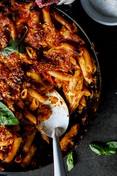 a skillet filled with pasta and sauce