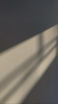 the shadow of a clock on a wall