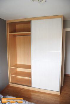 an empty closet is shown with white doors