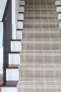 the stairs are lined with gray and white plaid carpet