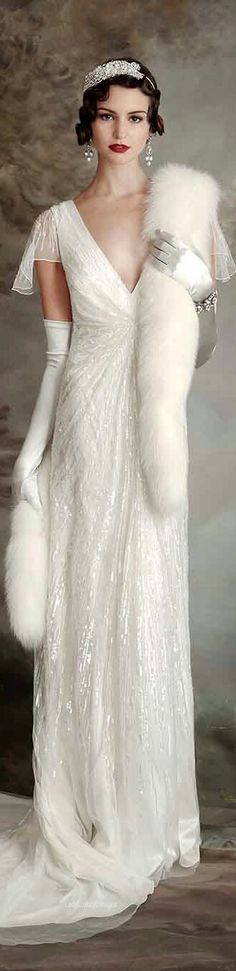 a woman in a white dress and fur stole