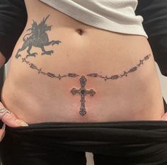 a woman with a cross tattoo on her stomach