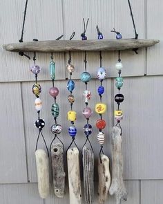 a wind chime hanging on the side of a building with lots of glass beads